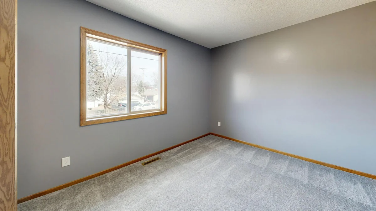 Interior real estate photo before window pull — windows blown out to pure white